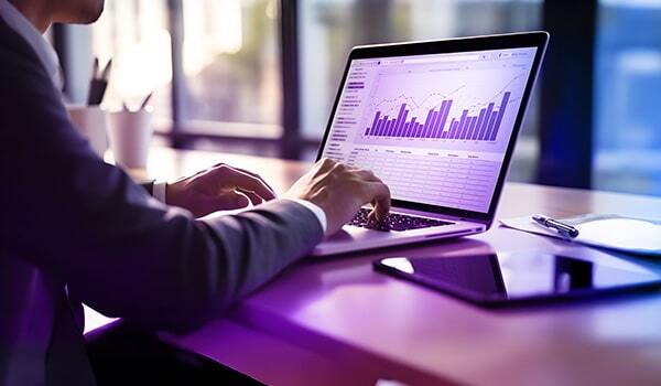 Person looking at charts on laptop